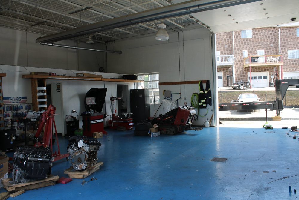 Inside the Top Notch shop: engines on stands, a tire balancer, and the open bay door